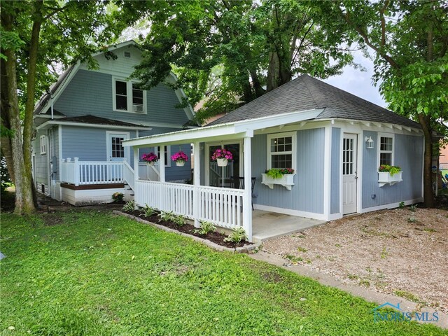 1019 Wayne Ave, Defiance, OH 43512 - view of front of house with a porch, a front yard, and roof with shingles