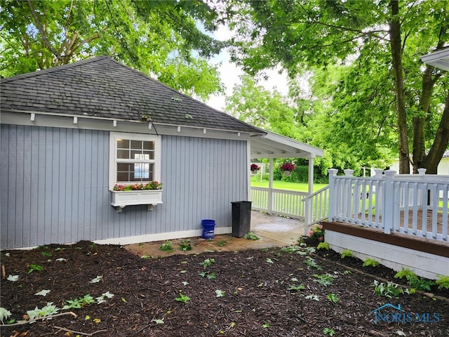 1019 Wayne Ave, Defiance, OH 43512 - view of side of home featuring a shingled roof and a deck