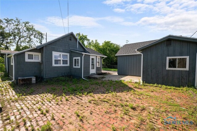 5542 N Summit St, Toledo, OH 43611 - view of side of home featuring board and batten siding and a patio