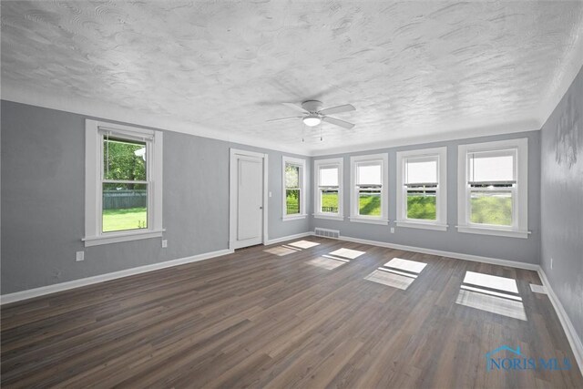 5542 N Summit St, Toledo, OH 43611 - empty room featuring a ceiling fan, a textured ceiling, and dark wood-style flooring