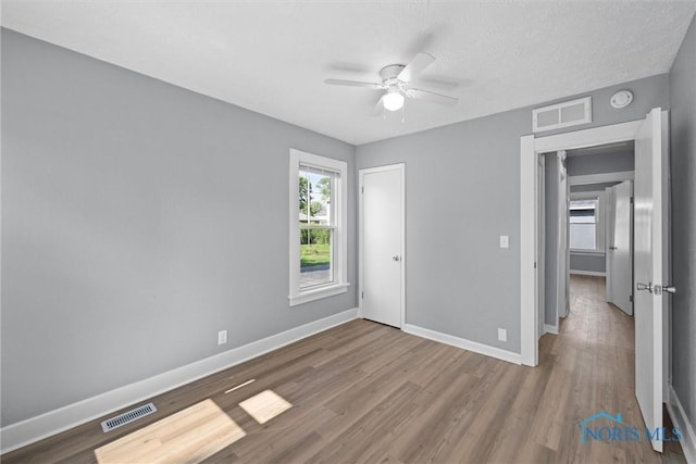 5542 N Summit St, Toledo, OH 43611 - unfurnished bedroom with wood finished floors and a ceiling fan