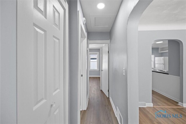 5542 N Summit St, Toledo, OH 43611 - hallway featuring wood finished floors and arched walkways