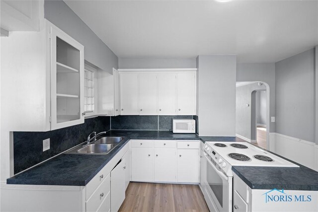 5542 N Summit St, Toledo, OH 43611 - kitchen featuring white appliances, a peninsula, dark countertops, and white cabinetry