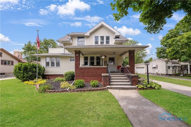 125 Cherry St, Wauseon, OH 43567 - bungalow-style house featuring a front lawn, brick siding, and covered porch