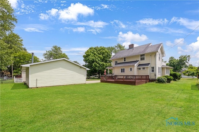 125 Cherry St, Wauseon, OH 43567 - back of house with a deck, a lawn, and a chimney