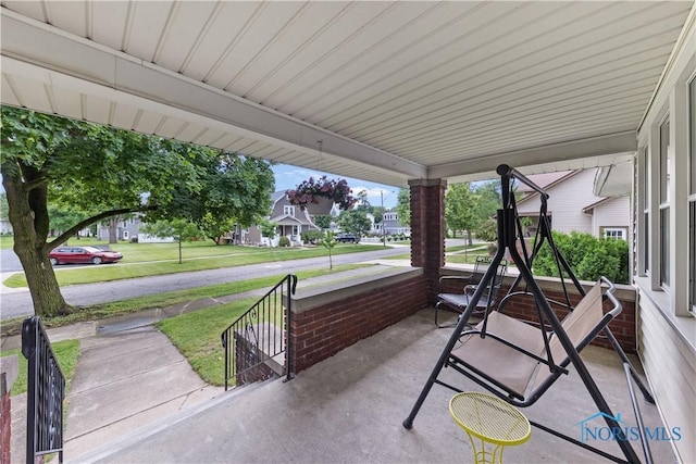 125 Cherry St, Wauseon, OH 43567 - covered porch featuring a residential view and a lawn