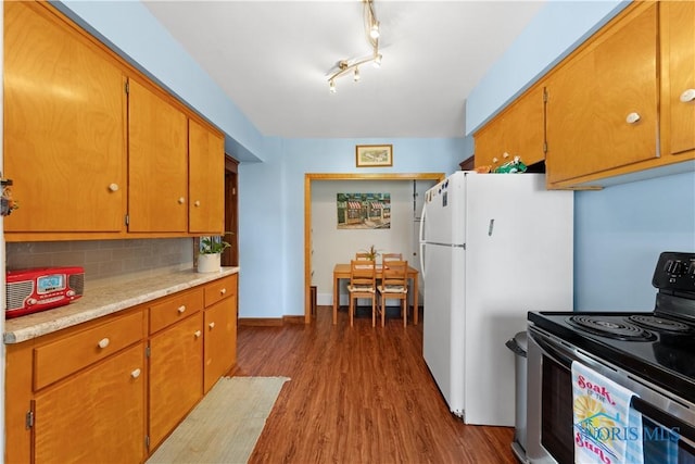 125 Cherry St, Wauseon, OH 43567 - kitchen featuring stainless steel range with electric stovetop, dark wood-style flooring, light countertops, tasteful backsplash, and freestanding refrigerator