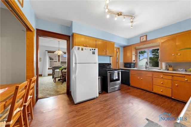 125 Cherry St, Wauseon, OH 43567 - kitchen featuring freestanding refrigerator, stainless steel electric range, black microwave, and wood finished floors