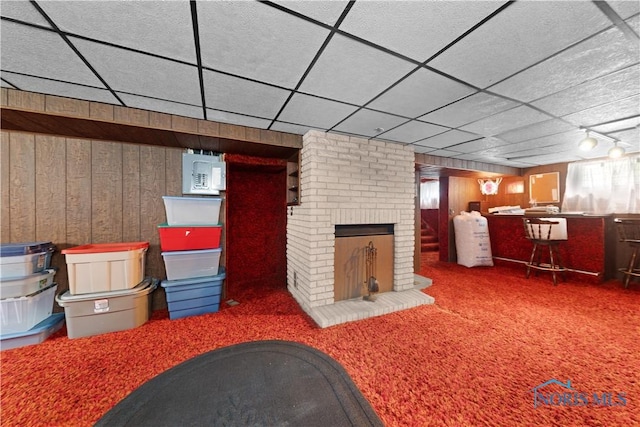 125 Cherry St, Wauseon, OH 43567 - finished below grade area featuring wood walls, carpet, and a brick fireplace