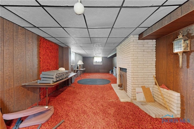 125 Cherry St, Wauseon, OH 43567 - interior space featuring wood walls, carpet, a fireplace, and a paneled ceiling