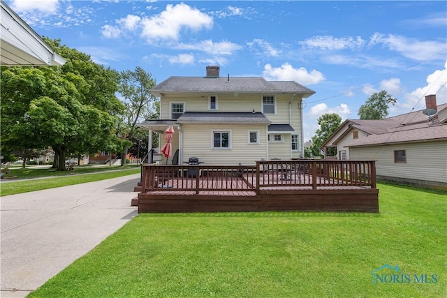 125 Cherry St, Wauseon, OH 43567 - rear view of property with a yard, a chimney, a deck, and concrete driveway