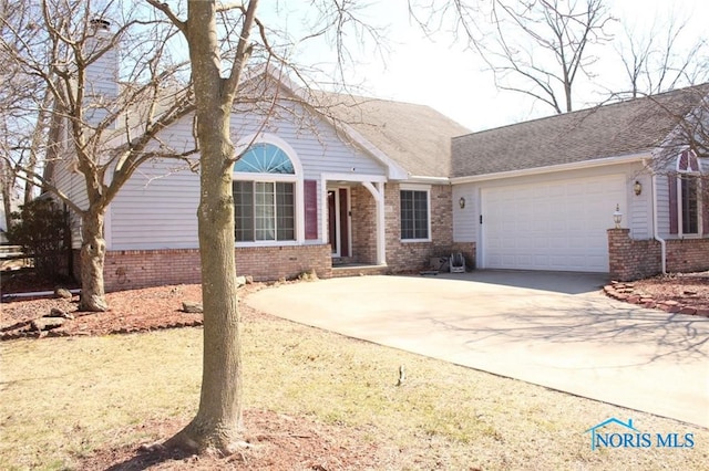 4871 Olde Meadow Ln, Sylvania, OH 43560 - single story home with brick siding, a garage, and concrete driveway