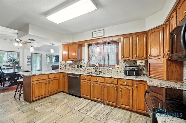 4871 Olde Meadow Ln, Sylvania, OH 43560 - kitchen featuring dishwasher, a peninsula, and brown cabinets