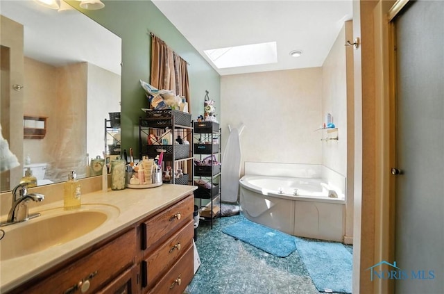 4871 Olde Meadow Ln, Sylvania, OH 43560 - bathroom with a skylight, vanity, and a garden tub