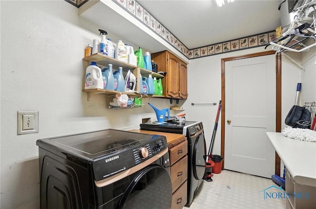 4871 Olde Meadow Ln, Sylvania, OH 43560 - laundry area featuring independent washer and dryer, cabinet space, and light flooring