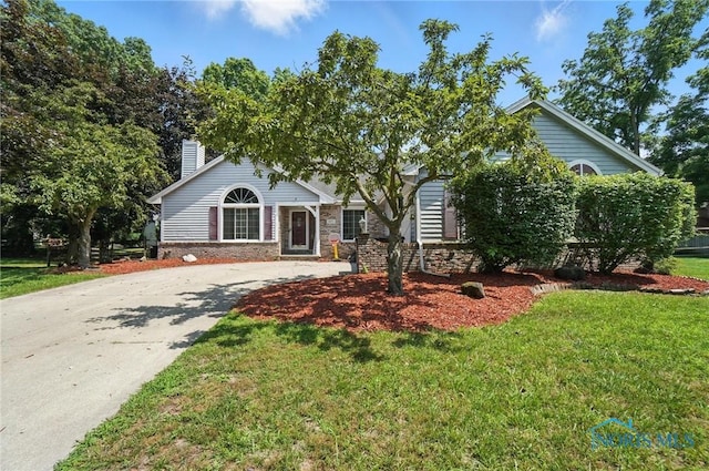 4871 Olde Meadow Ln, Sylvania, OH 43560 - obstructed view of property featuring a front lawn, a chimney, driveway, and brick siding