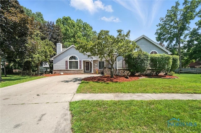 4871 Olde Meadow Ln, Sylvania, OH 43560 - view of front of property featuring driveway, a front yard, and a chimney