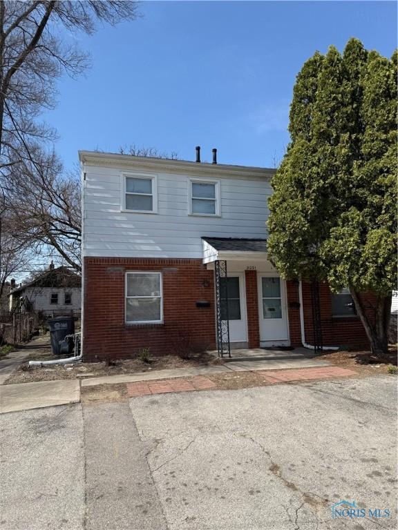3031 Douglas Rd, Toledo, OH 43606 - view of front facade with brick siding and a porch