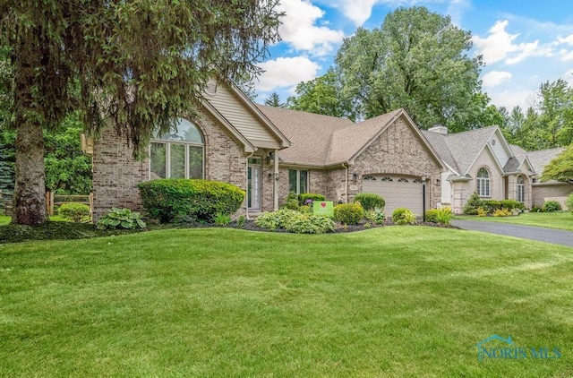 2923 Belle Glade Dr, Toledo, OH 43617 - ranch-style house with an attached garage, a front lawn, asphalt driveway, brick siding, and roof with shingles