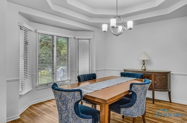 2923 Belle Glade Dr, Toledo, OH 43617 - dining room featuring a raised ceiling, a chandelier, and wood finished floors