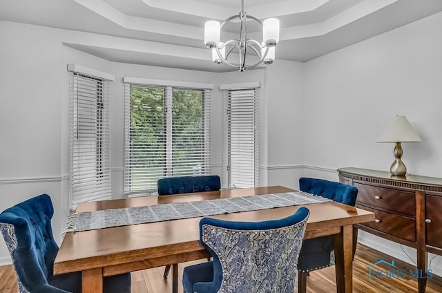 2923 Belle Glade Dr, Toledo, OH 43617 - dining area featuring a chandelier, a tray ceiling, and wood finished floors