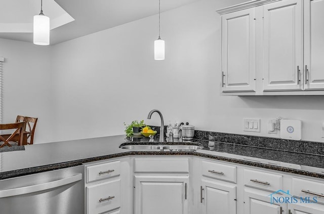 2923 Belle Glade Dr, Toledo, OH 43617 - kitchen with stainless steel dishwasher, white cabinets, decorative light fixtures, and dark stone counters