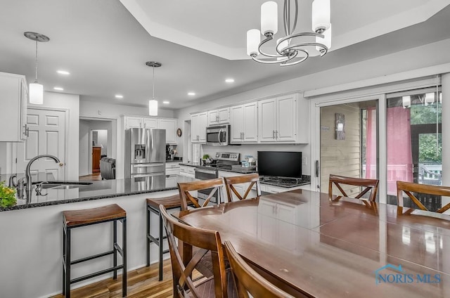 2923 Belle Glade Dr, Toledo, OH 43617 - kitchen with appliances with stainless steel finishes, a peninsula, white cabinetry, recessed lighting, and pendant lighting