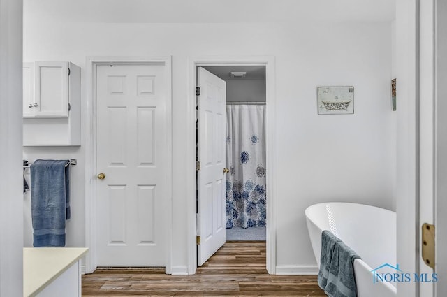 2923 Belle Glade Dr, Toledo, OH 43617 - full bath with wood finished floors, vanity, and a freestanding bath