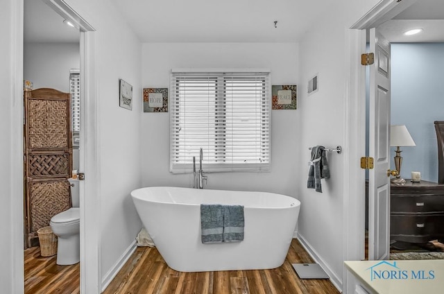 2923 Belle Glade Dr, Toledo, OH 43617 - bathroom featuring a freestanding bath and wood finished floors