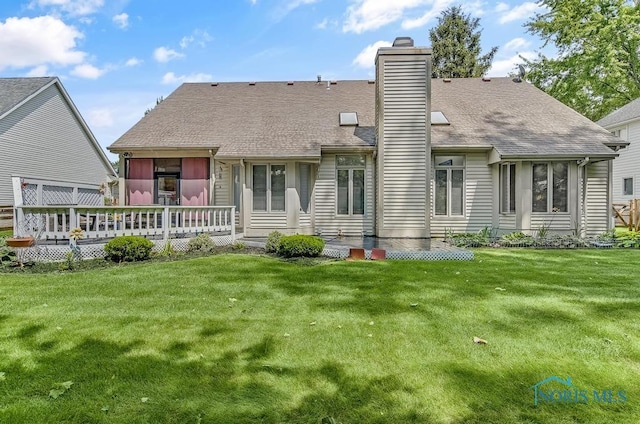 2923 Belle Glade Dr, Toledo, OH 43617 - back of house with a chimney, a yard, a wooden deck, and roof with shingles