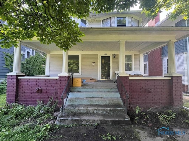 2631 Parkwood Ave, Toledo, OH 43610 - doorway to property with covered porch and brick siding