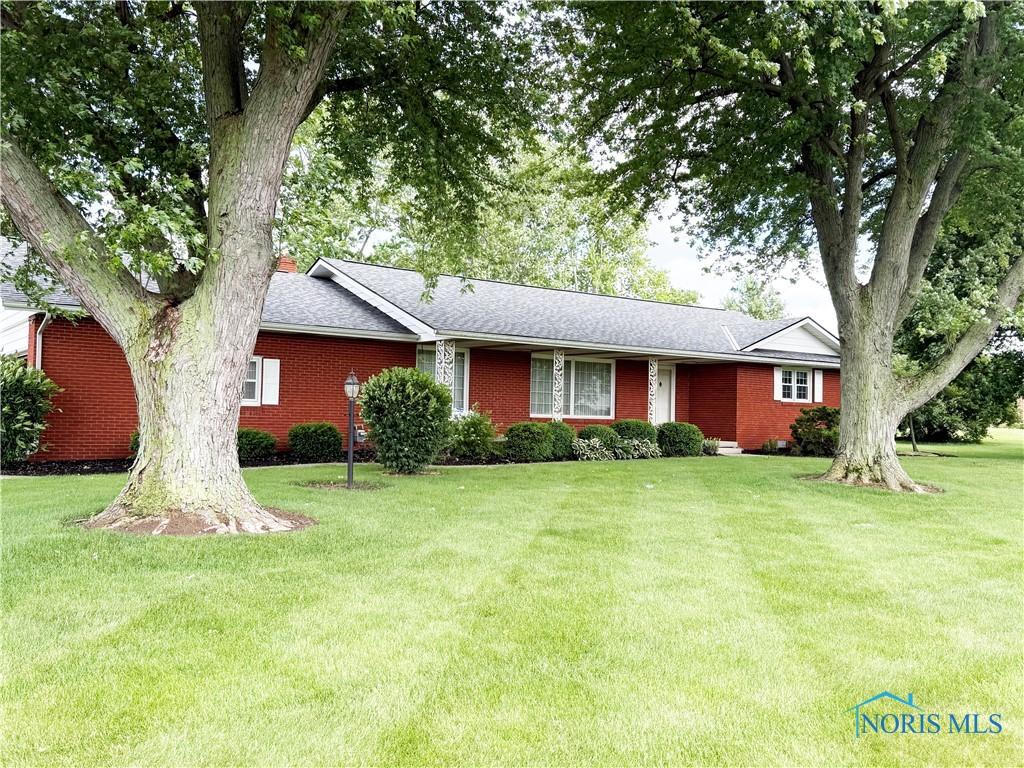 3476 Gwilym Rd, Fostoria, OH 44830 - ranch-style home with a front lawn, brick siding, and a shingled roof