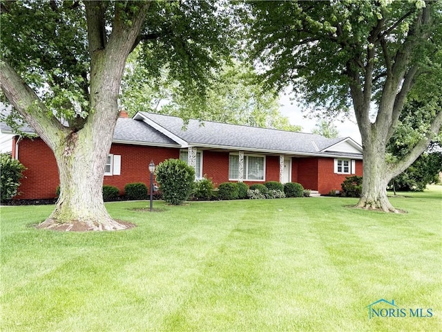 3476 Gwilym Rd, Fostoria, OH 44830 - ranch-style home with a front lawn, brick siding, and a shingled roof