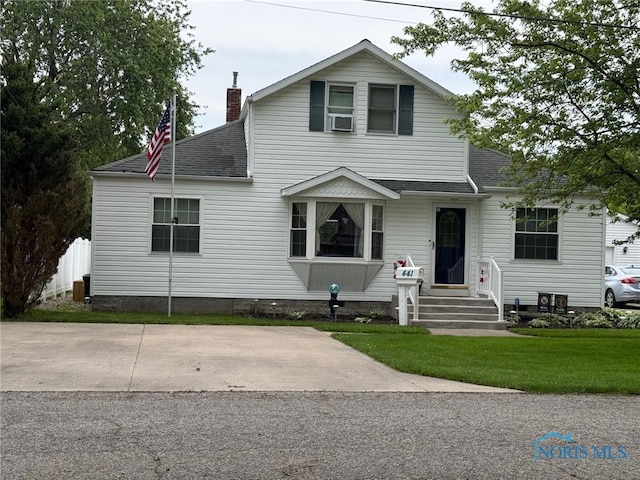 441 S Pine St, Deshler, OH 43516 - traditional-style home featuring roof with shingles, a chimney, a front lawn, and cooling unit