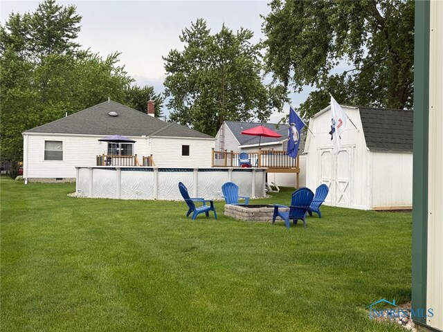 441 S Pine St, Deshler, OH 43516 - view of grassy yard featuring a storage shed, a wooden deck, and a swimming pool