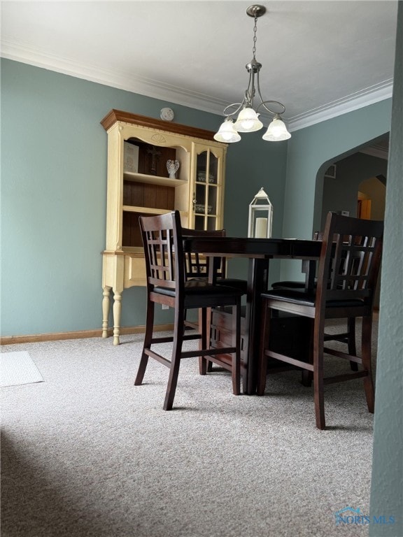441 S Pine St, Deshler, OH 43516 - carpeted dining space with arched walkways, crown molding, and a chandelier