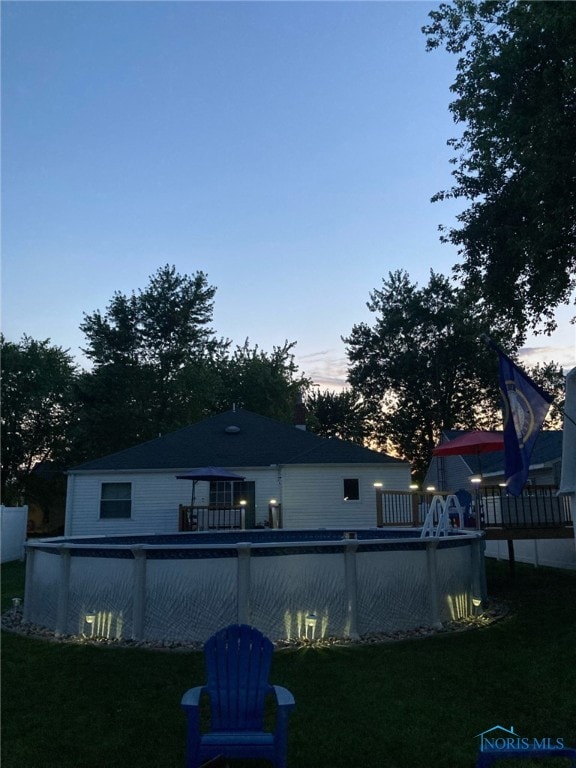 441 S Pine St, Deshler, OH 43516 - rear view of property with a lawn, an outdoor pool, and a wooden deck