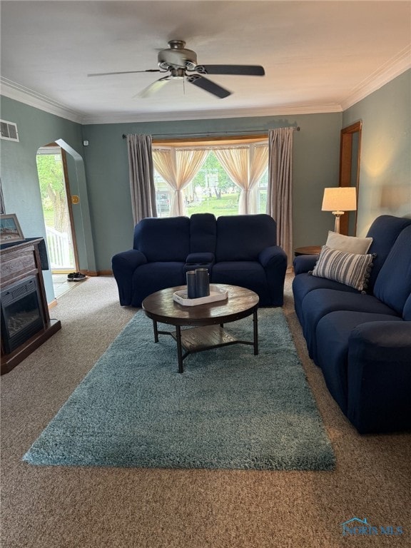 441 S Pine St, Deshler, OH 43516 - carpeted living room with healthy amount of natural light, ornamental molding, a ceiling fan, and arched walkways