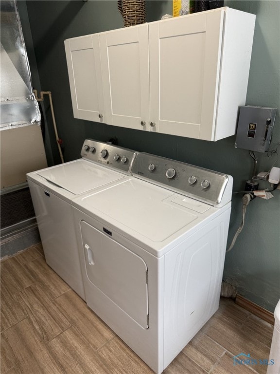 441 S Pine St, Deshler, OH 43516 - laundry area with cabinet space, washing machine and dryer, and wood tiled floors