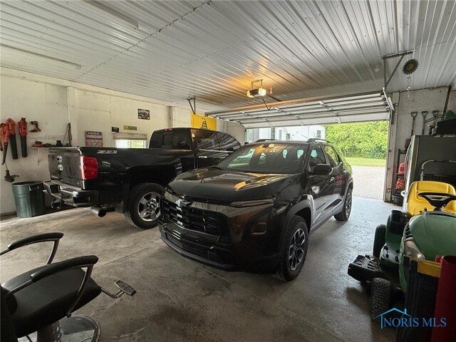 441 S Pine St, Deshler, OH 43516 - garage with a garage door opener and freestanding refrigerator