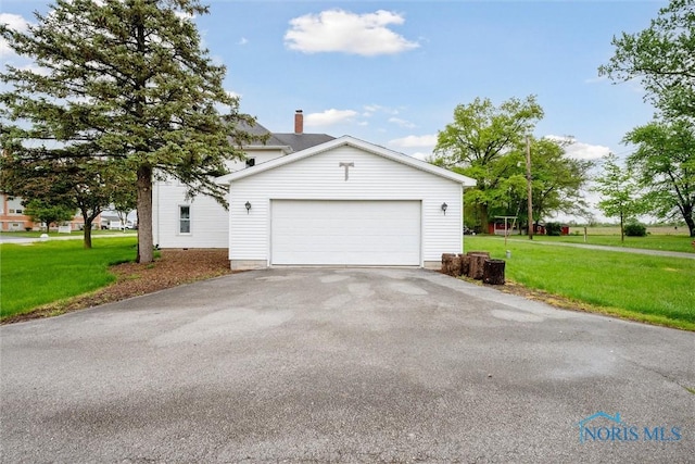 22767 Defiance Pike, Custar, OH 43511 - view of property exterior with a lawn, asphalt driveway, and an attached garage