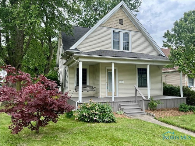 1810 E Broadway St, Toledo, OH 43605 - view of front facade featuring a porch, a front yard, and a shingled roof