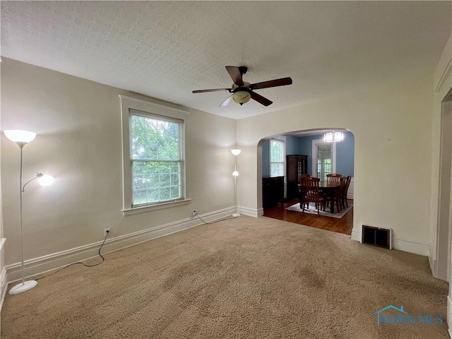 1810 E Broadway St, Toledo, OH 43605 - carpeted spare room featuring arched walkways and a ceiling fan