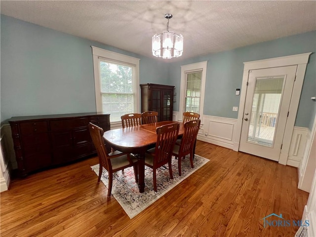 1810 E Broadway St, Toledo, OH 43605 - dining room with a chandelier, light wood-style floors, and wainscoting