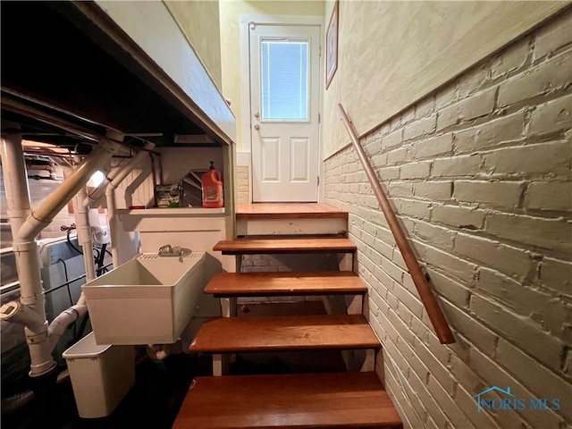 1810 E Broadway St, Toledo, OH 43605 - staircase featuring brick wall