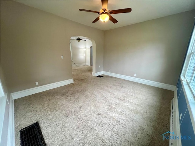1810 E Broadway St, Toledo, OH 43605 - carpeted spare room featuring a ceiling fan and arched walkways