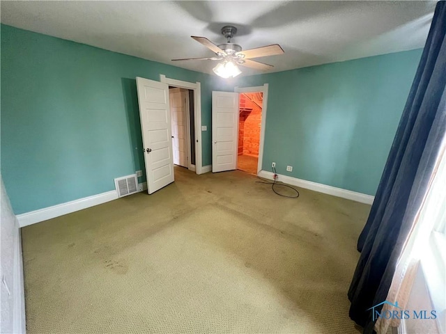 1810 E Broadway St, Toledo, OH 43605 - unfurnished bedroom featuring carpet floors, ceiling fan, a walk in closet, and a closet