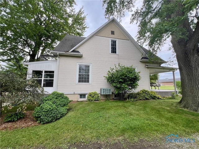1810 E Broadway St, Toledo, OH 43605 - view of side of home with a yard and roof with shingles