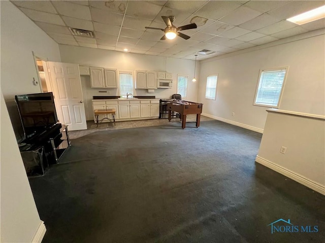 1810 E Broadway St, Toledo, OH 43605 - interior space featuring ceiling fan, a paneled ceiling, and dark colored carpet