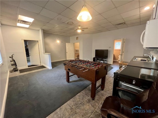 1810 E Broadway St, Toledo, OH 43605 - playroom with a paneled ceiling, dark colored carpet, and a ceiling fan